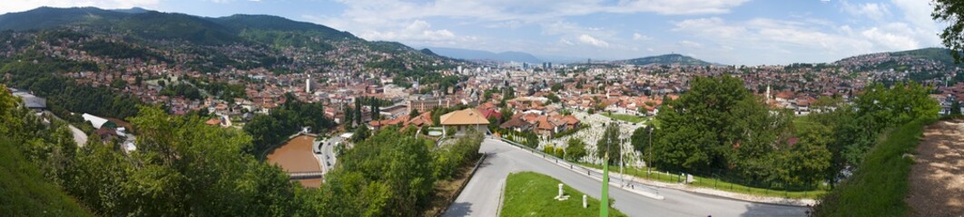 Fototapeta na wymiar Bosnia and Herzegovina: aerial view of the skyline of the capital Sarajevo, surrounded by the Dinaric Alps and situated along the Miljacka River, seen from Zuta Tabija (Yellow Fortress) 