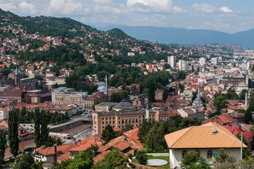 Fototapeta na wymiar Bosnia and Herzegovina: aerial view of the skyline of the capital Sarajevo, surrounded by the Dinaric Alps and situated along the Miljacka River, seen from Zuta Tabija (Yellow Fortress) 