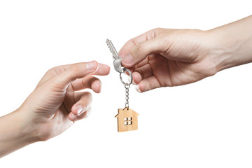 Hands of two people, giving and taking keys, isolated on white background