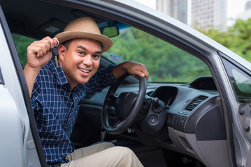 Asian man holding a car key