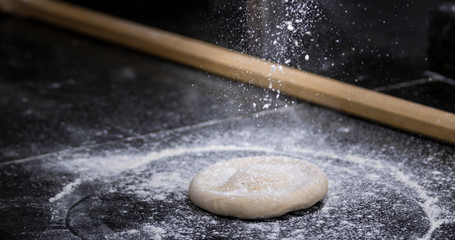 Preparing dough for pizza