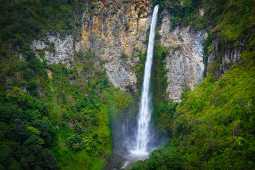 Sipiso-piso waterfall famous travel destination natural landmark and tourist attraction in Berastagi and Lake Toba, Sumatra Indonesia. Long exposure, vignetting.