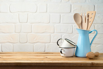 Vintage kitchen utensils and tableware on wooden table