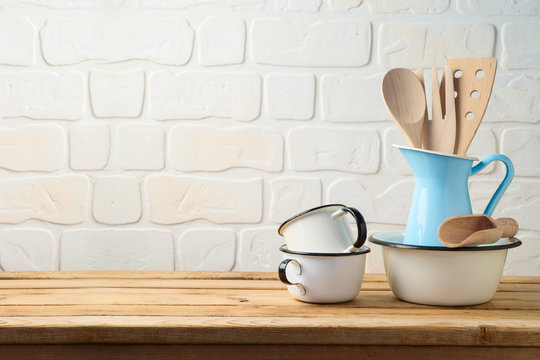 Vintage kitchen utensils and tableware on wooden table