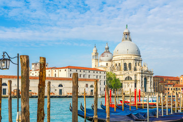 view of Canal Grande with historic Basilica di Santa Maria della Salute in the background and gondolas Venice, Italy