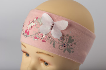 Head of child mannequin with bandage for girls on white background.