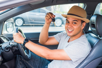 Asian man holding a car key