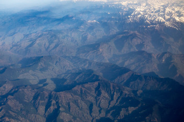 Aerial view from top of Himalayan mountains from the airplane window with Snow cover all of...
