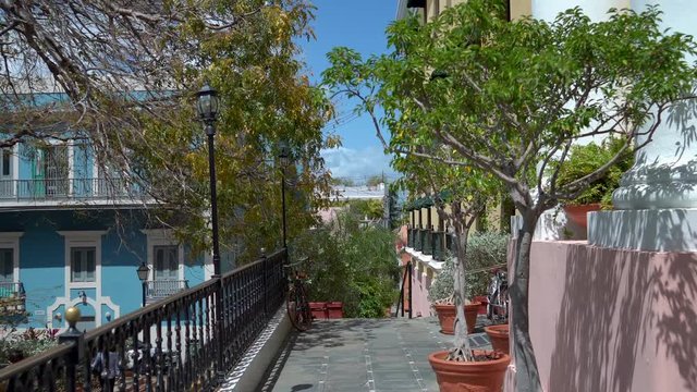 A moving gimbal shot through a terrace of a colorfully​ painted townhouse in Viejo San Juan, Puerto Rico.