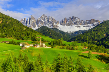 Famous alpine Santa Maddalena village with Dolomites mountains in background, Val di Funes valley