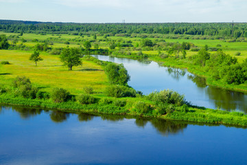 Landscape. Nature. River. Meadow. Green grass. Blue sky with clouds