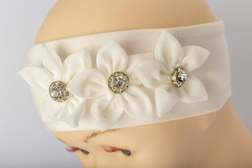 Head of child mannequin with bandage for girls on white background.