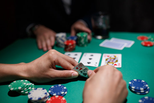 poker player bets all chips. Big poker risks. poker table and hands close-up