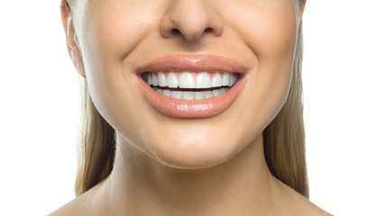 Close up photo of a female smile. Dental concept. Isolated on white background.