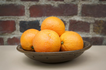 Plate oranges Brick wall background