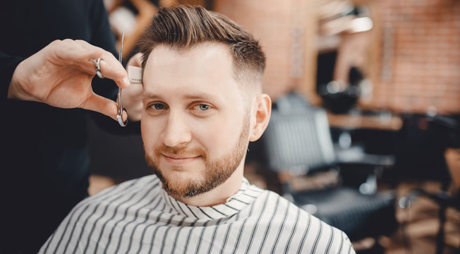Barbershop concept. Hairdressers barber haircut men in salon.