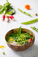 Summer pea soup with fresh vegetables