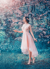 pretty slender girl with braided dark hair in a delicate elegant peach dress, a fairy-tale princess in a frozen flowering forest, a gentle image of the forest queen, fairy in love, creative colors