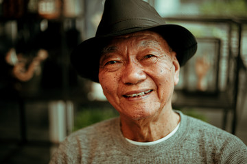 Asian senoir old man retirement drinking coffee in cafe smile and happy face
