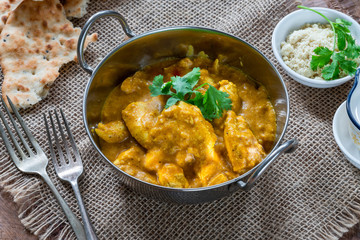 Chicken korma curry with naan bread - high angle view