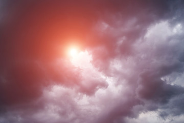 Epic scenic storm dark clouds background with sun and orange sunlight. Darkness and light	
