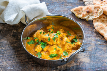 Chicken korma curry with naan bread - high angle view