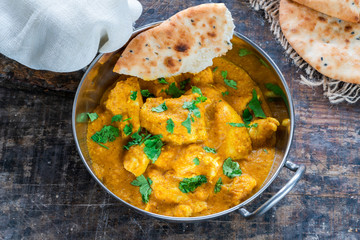Chicken korma curry with naan bread - high angle view