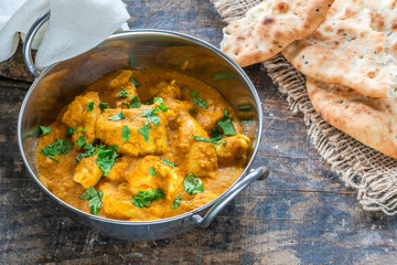 Chicken korma curry with naan bread - high angle view