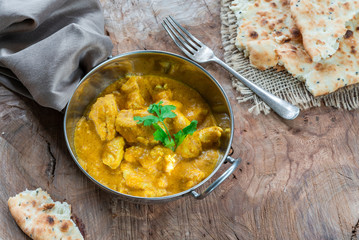 Chicken korma curry with naan bread - high angle view