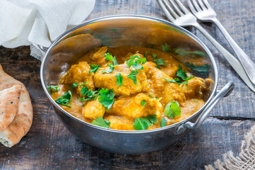 Chicken korma curry with naan bread - high angle view