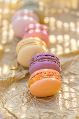 french pastries. Dessert of macarons in the summer evening in the orchard. Natural blurred background. Shallow depth of field