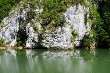 Naklejka na ściany i meble Reflection of the stone in the lake