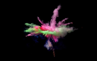 Fantastic forms of powder paint and flour combined  together explode in front of a black background to give off fantastic  color explosions in bizarre multi colored cloud forms.