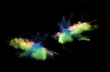 Fantastic forms of powder paint and flour combined  together explode in front of a black background to give off fantastic  color explosions in bizarre multi colored cloud forms.