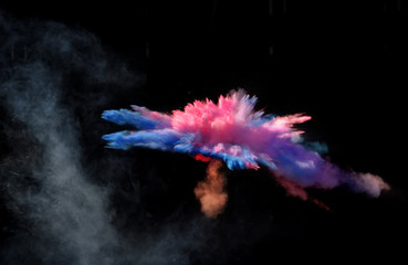 Fantastic forms of powder paint and flour combined  together explode in front of a black background...