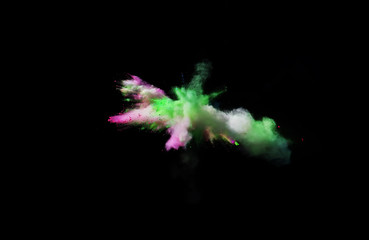 Fantastic forms of powder paint and flour combined  together explode in front of a black background...