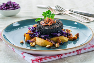 Warm salad of red cabbage, black pudding and apple with crispy bacon and crushed hazelnuts -...