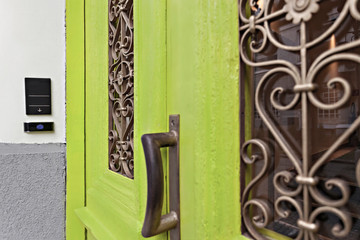 Detail of a doorknob and door intercom, building entrance