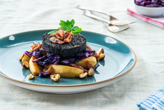 Warm salad of red cabbage, black pudding and apple with crispy bacon and crushed hazelnuts.
