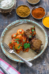 Spiced lamb cutlets with Bombay aloo with minted yogurt - overhead view
