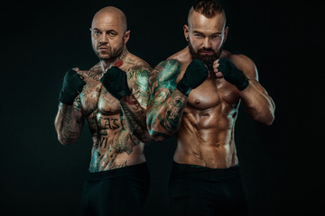 Two Sportsmans boxers fighting on black background. Copy Space. Boxing sport concept.