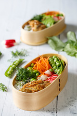 Japanese style bento lunch box with chicken, rice and vegetables