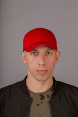 Handsome young man in a headdress on a gray background.