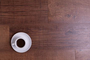Top view of white espresso coffee cup with espresso coffee on white saucer