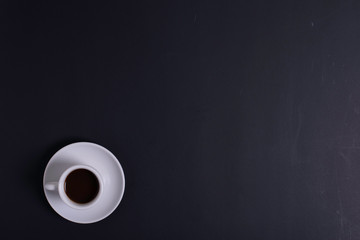 Top view of white espresso coffee cup with espresso coffee on white saucer