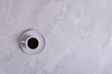 Top view of white espresso coffee cup with espresso coffee on white saucer