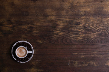 Top view of white espresso coffee cup with espresso coffee and foamy milk on white saucer