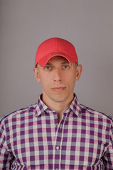 Handsome young man in a headdress on a gray background.