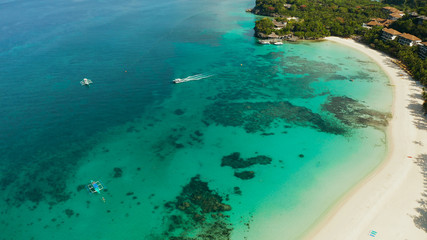 Fototapeta na wymiar White sandy beach with tourists and hotels in Boracay Island, Philippines, aerial view. Seascape with beach on tropical island. Summer and travel vacation concept.