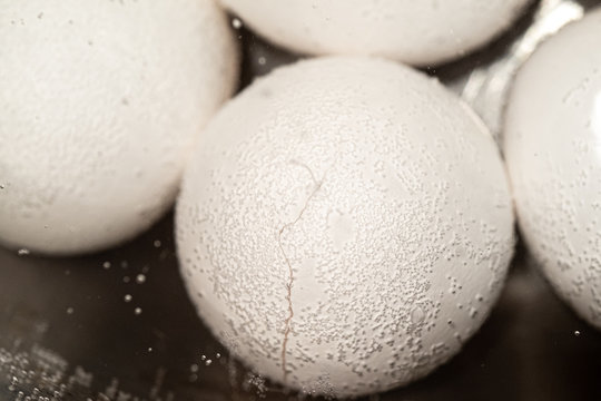 cracked egg in boiling water